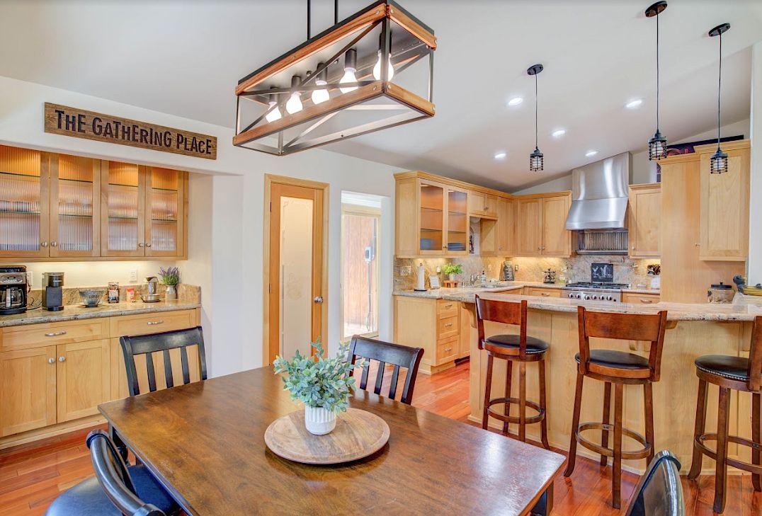 Dining room with 'The Gathering Place' sign, coffee bar, and open kitchen with island seating