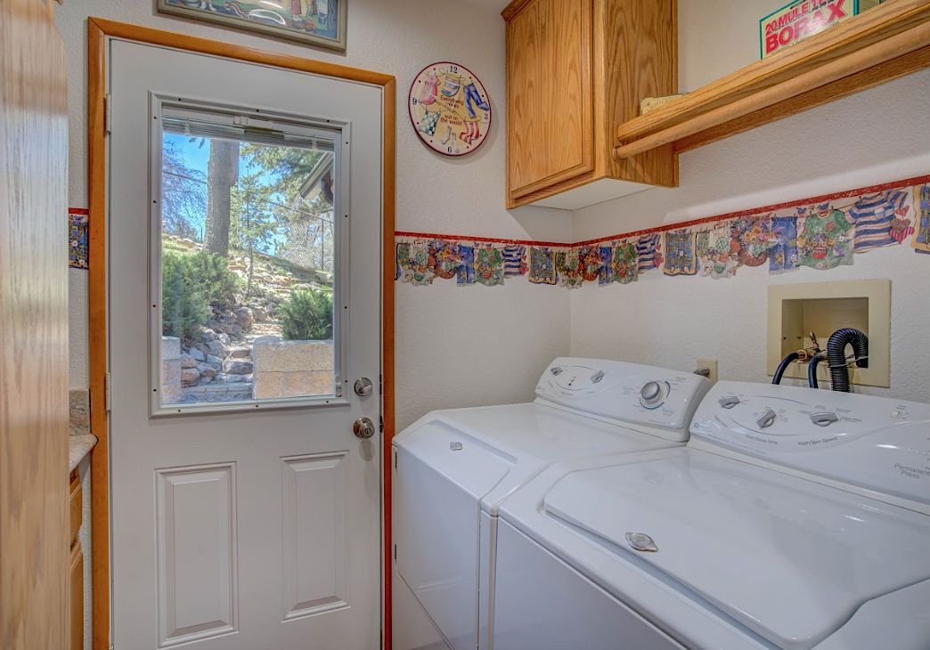 Laundry room with full-size washer and dryer and door to the outdoors