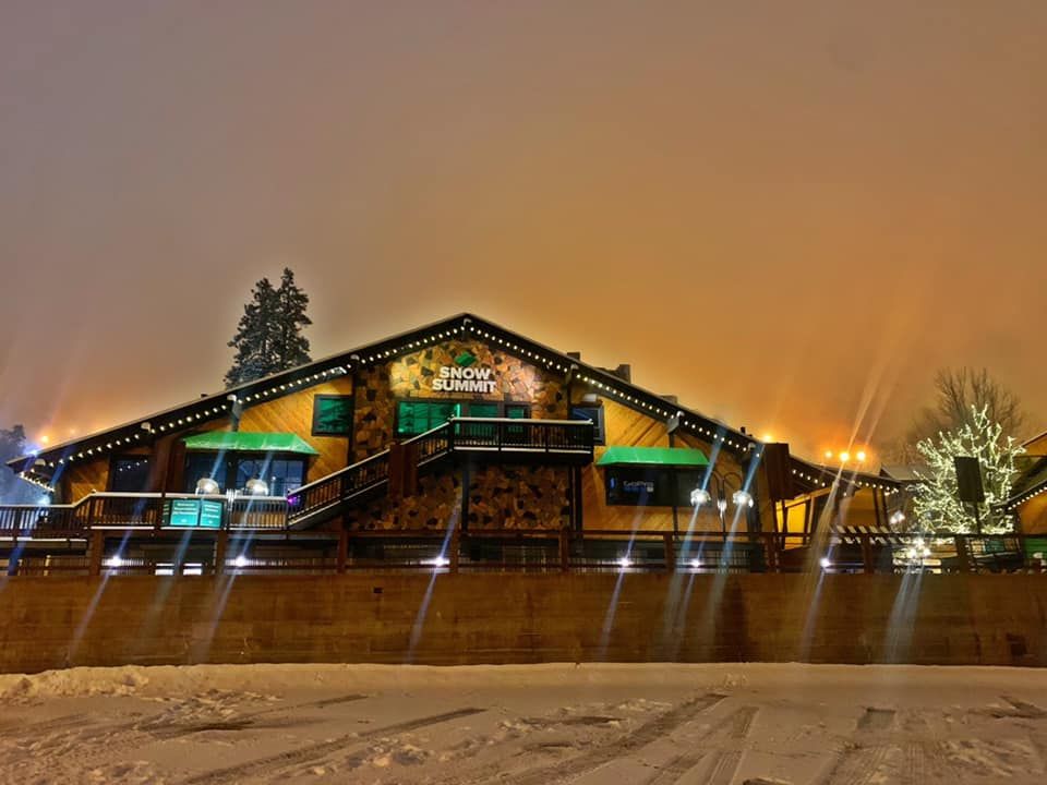 Snow Summit ski resort lodge glowing at night in the snow